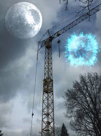 Low angle view of cranes against sky at night