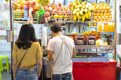 Thailand is khao san road. asian women tourists are buying juice, street food of thailand concept