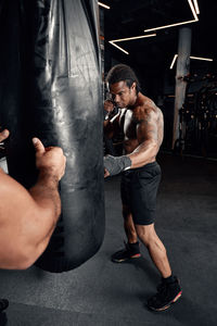 Low section of man exercising in gym