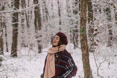 Rear view of woman standing in forest