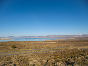 Scenic view of landscape against clear blue sky