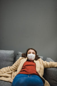 Woman sitting on sofa at home