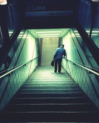 Rear view of woman walking on staircase