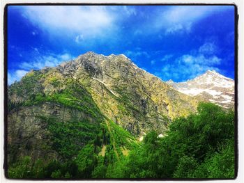 Scenic view of mountains against blue sky