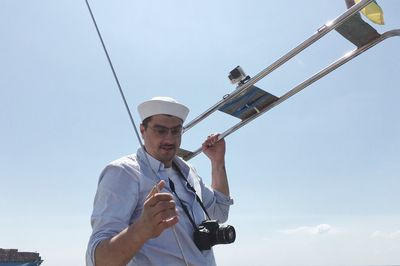 Low angle view of man standing against sky