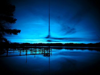 Scenic view of lake against sky at night