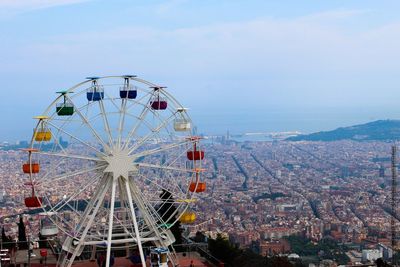 Ferris wheel in city against sky