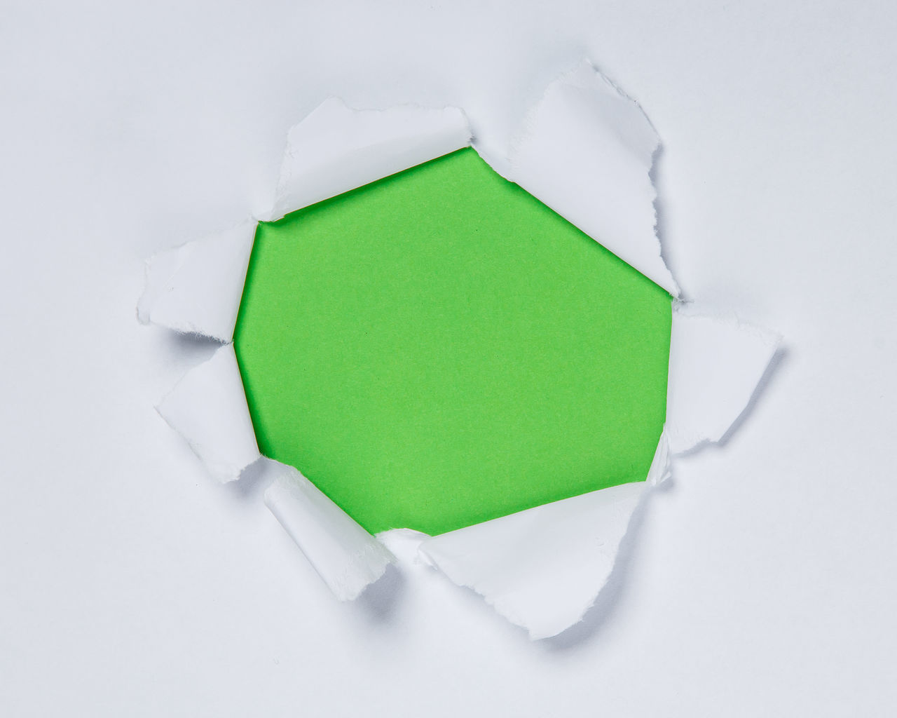 HIGH ANGLE VIEW OF GREEN PAPER ON WHITE BACKGROUND