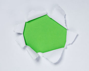 High angle view of green paper against white background