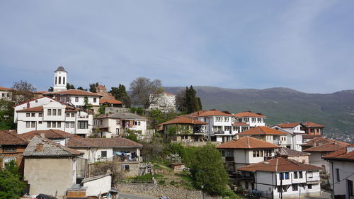 Houses in town against sky