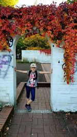 Full length of woman on footpath during autumn