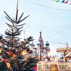 Christmas tree by orthodox church against sky during winter