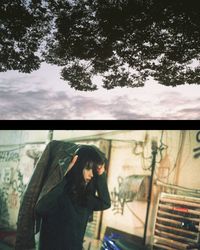 Close-up of woman by window against tree