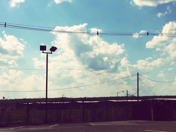 Low angle view of road sign against sky