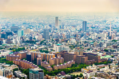 High angle view of modern buildings in city against sky