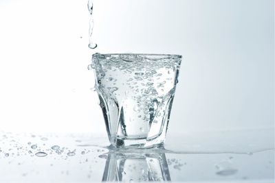 Close-up of water splashing against white background