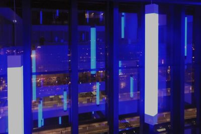 Close-up of illuminated glass window of building at night