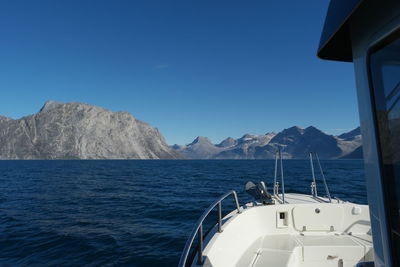 Sailboat sailing in sea against clear blue sky