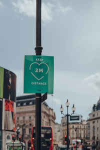 Information sign on road against sky