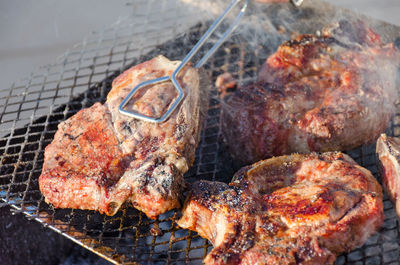 High angle view of meat on barbecue grill