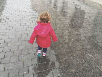 Rear view of girl wearing raincoat