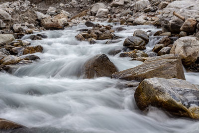 Scenic view of stream flowing through rocks