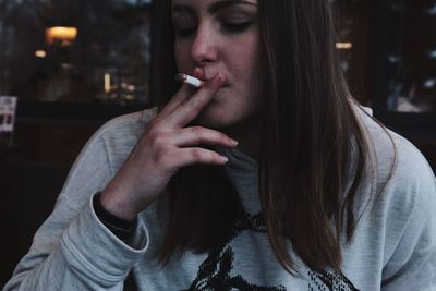 Young woman smoking cigarette