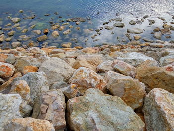 High angle view of rocks against sea