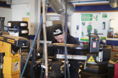 Man changing tire in garage