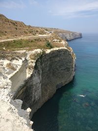 High angle view of rocks by sea against sky