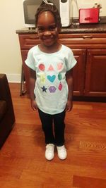 Portrait of smiling girl standing at home