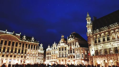 Low angle view of buildings in city at night