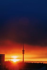 Silhouette tower against sky during sunset