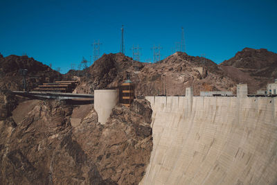 Hoover dam by rocky mountain against sky