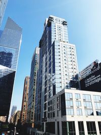 Low angle view of modern buildings against sky in city