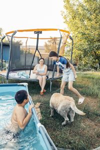 Rear view of man with dog in park