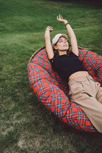 Young woman lying on field