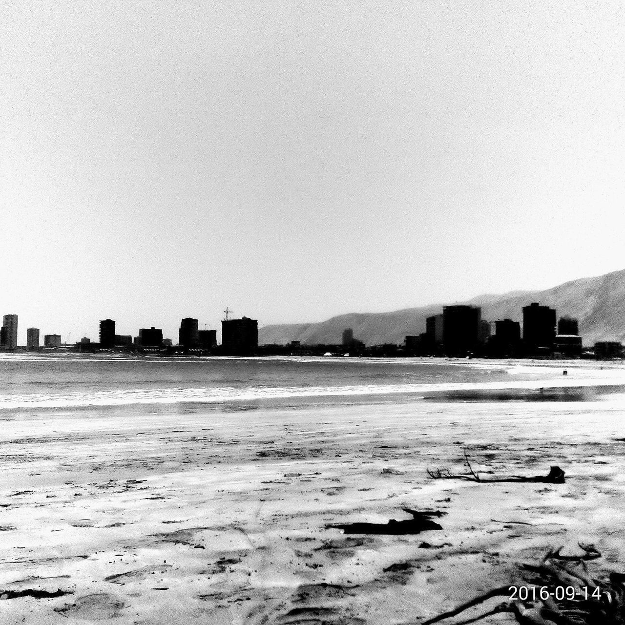 BUILDINGS ON SHORE AGAINST CLEAR SKY IN CITY