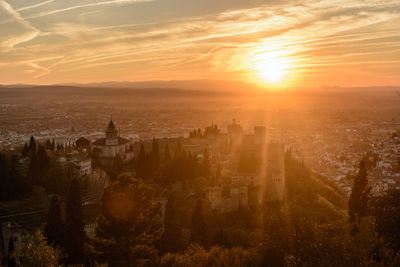 High angle view of buildings in city during sunset