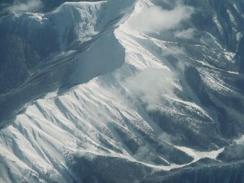 Aerial view of snow covered mountains