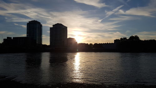 Silhouette buildings against sky during sunset