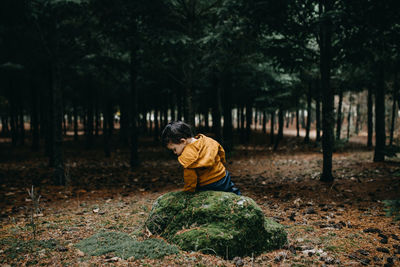 Child sitting on the rock