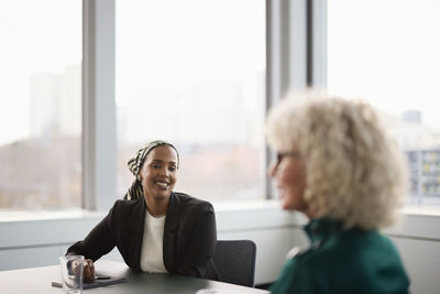 Smiling woman at business meeting