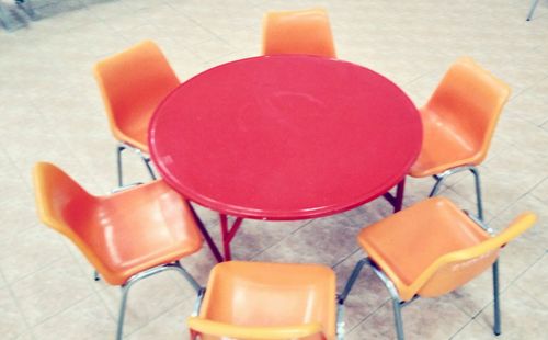 Close-up of multi colored chairs on table