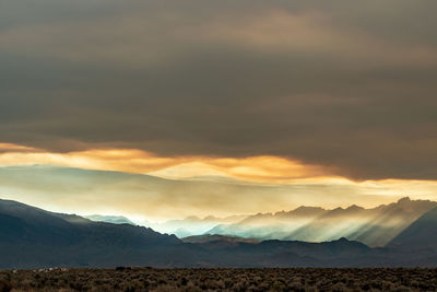 Sunlight in god rays beam from massive forest fire smoke cloud  sierra nevada mountains california