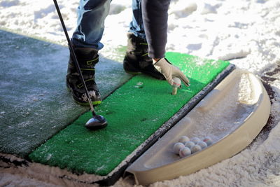 Low section of man playing golf