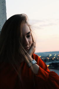 Portrait of young woman against sea against sky