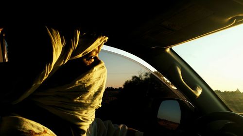 Portrait of man seen through car windshield