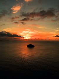 Scenic view of sea against romantic sky at sunset