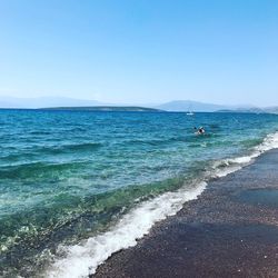 Scenic view of sea against clear blue sky